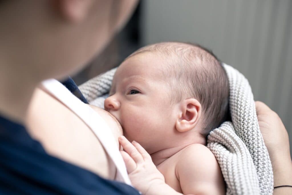Mom breastfeeds baby littledot
